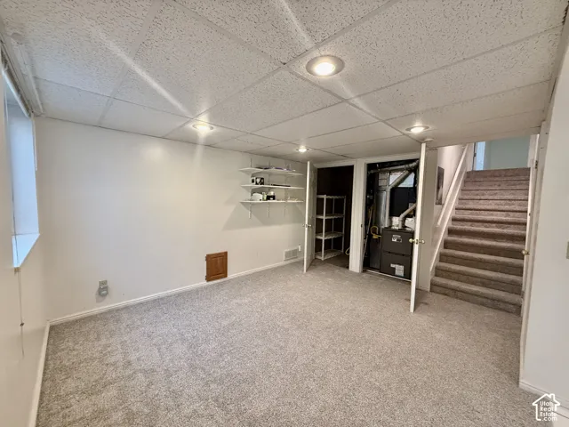 Carpeted room with recessed lighting and a drop ceiling