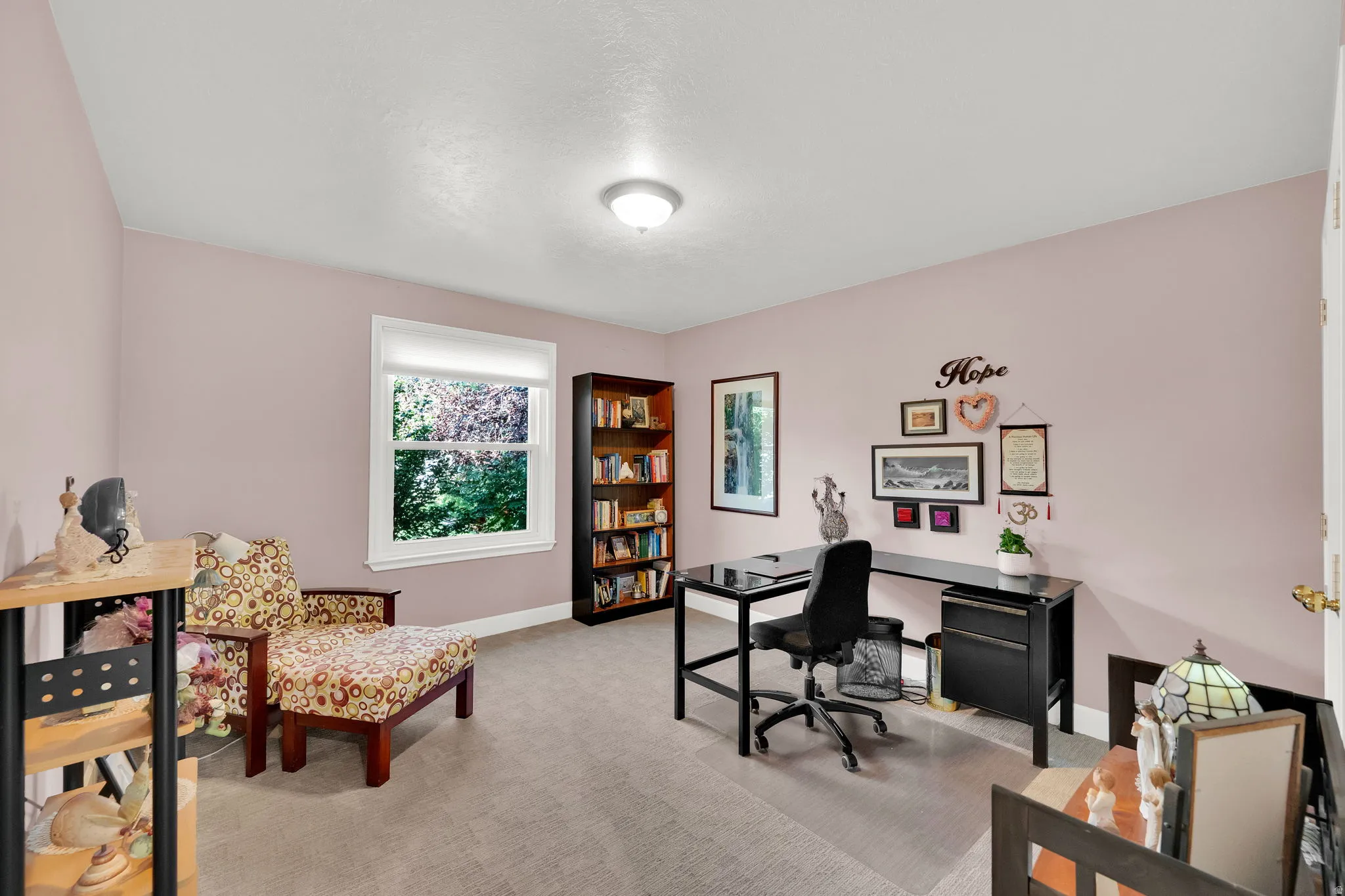 Neutral wall color, window with white trim, recessed lighting, built-in shelving, and carpeted flooring
