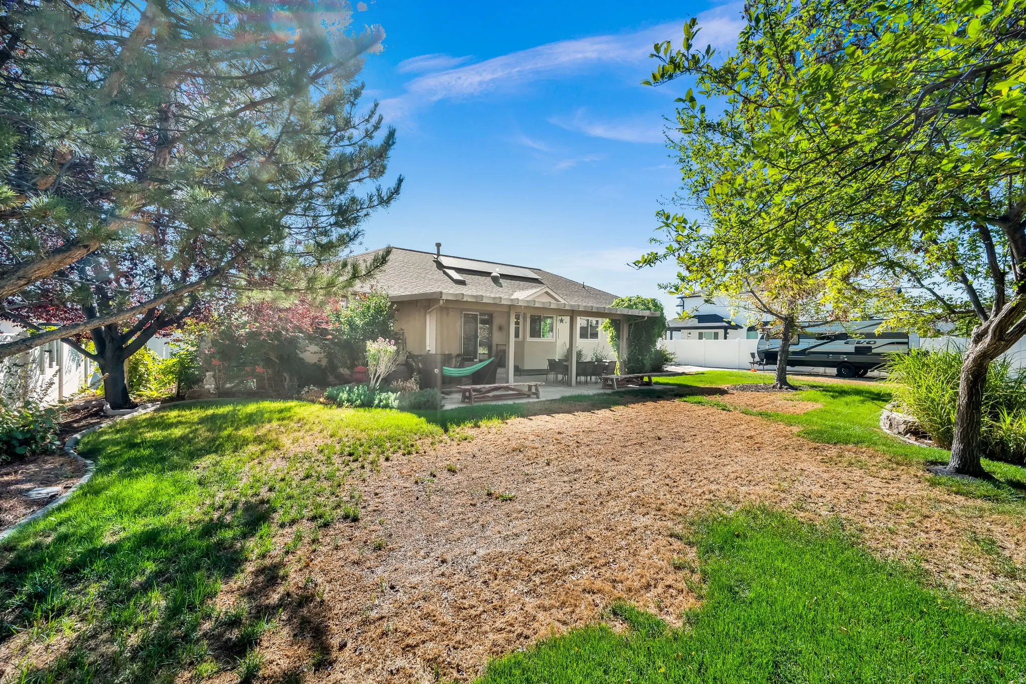 Charming residence set on expansive grounds with mature shade trees framing the property