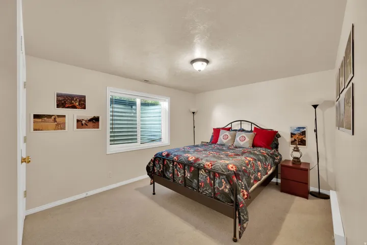 Carpeted room with neutral-toned walls, a white window frame, and a flush mount ceiling light fixture