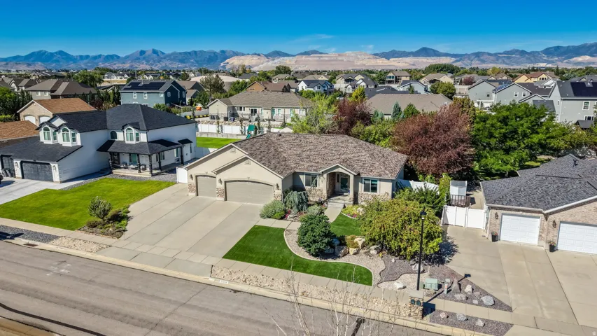 Expansive front yard with manicured lawn and mature landscaping