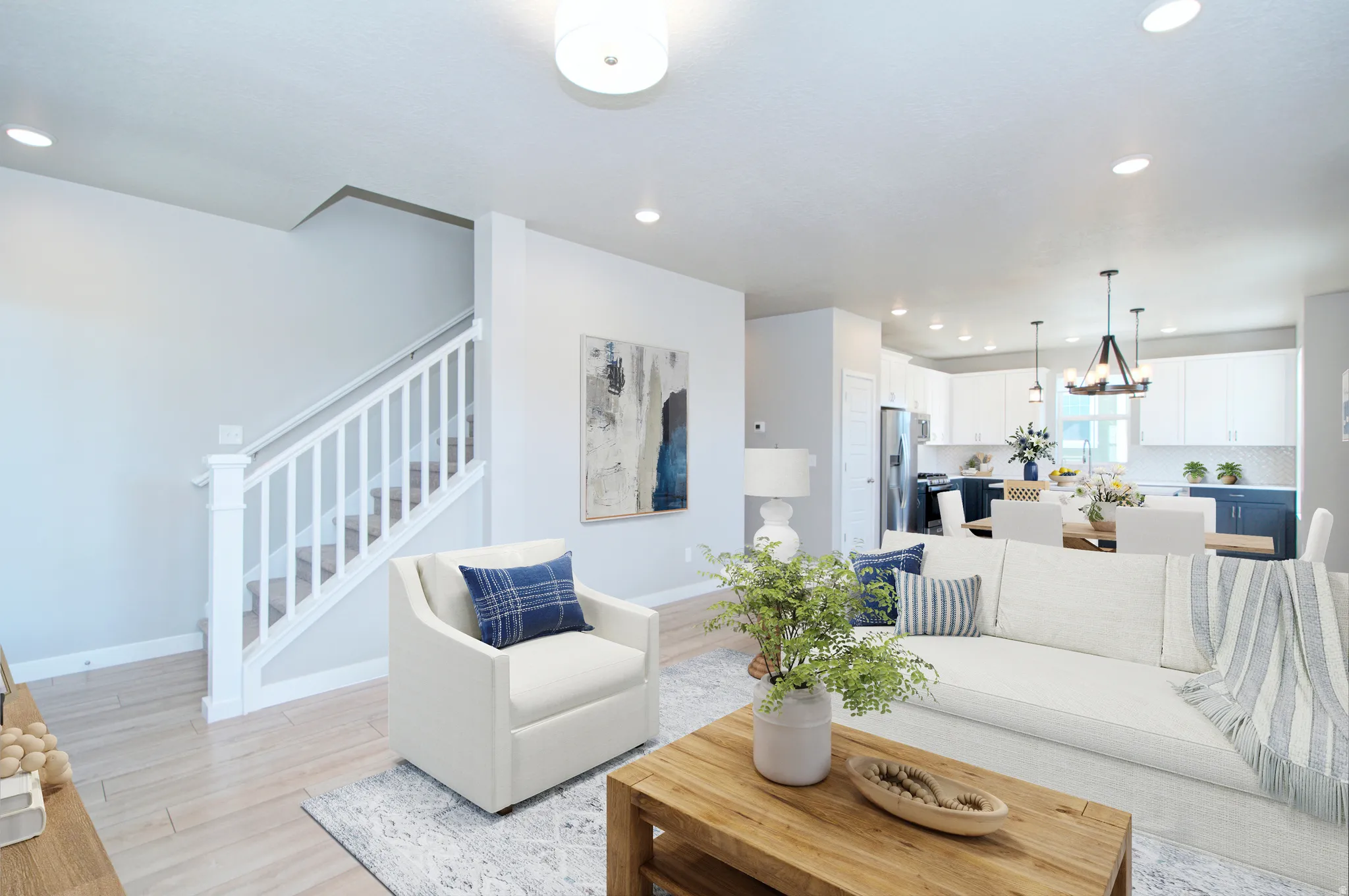 Recessed lighting, wood-finish flooring, white staircase with railing, white shaker kitchen cabinetry, and pendant lighting