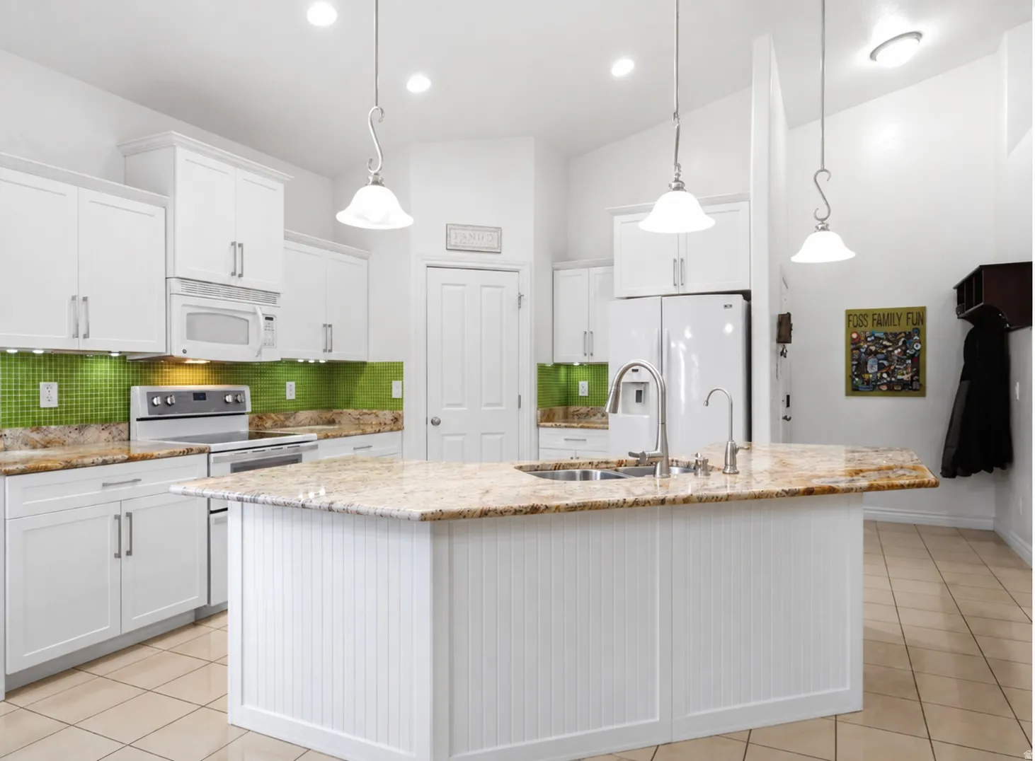 Upgraded kitchen features white shaker skyline cabinetry, under-cabinet lighting, granite countertops, Bosch dishwasher, reverse-osmosis system & double ovens.