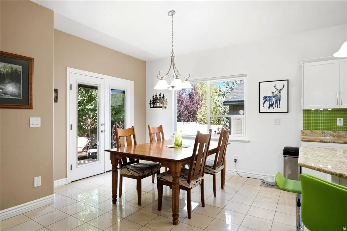 The large dining area is filled with natural light and provides direct access to the custom backyard retreat.