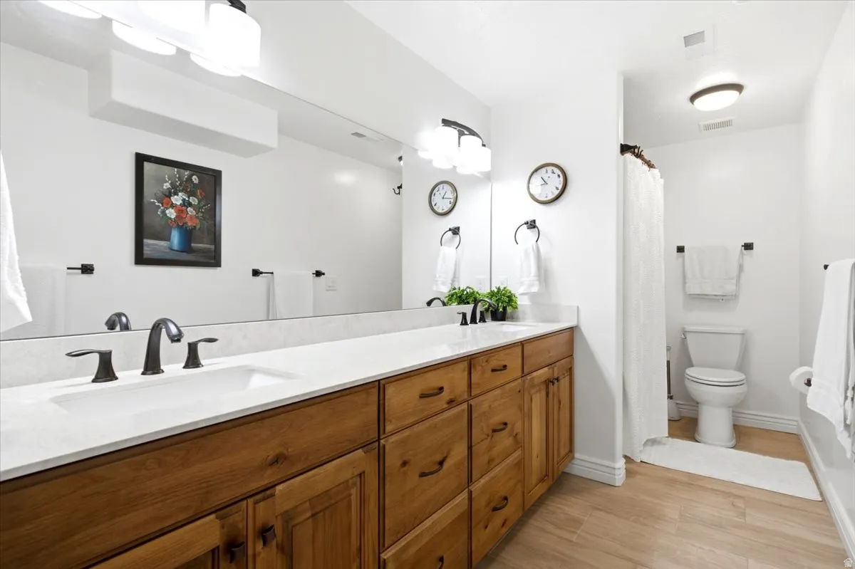 The newly finished basement bathroom features a spacious double vanity and modern finishes.