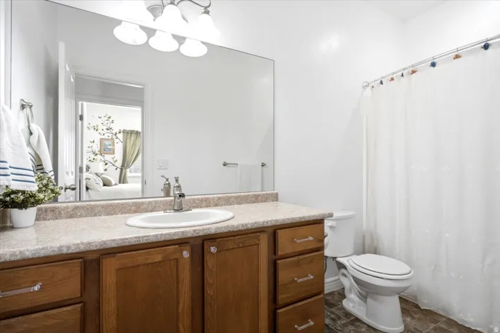 A well-appointed secondary bathroom features a spacious vanity and a tub and shower combination.
