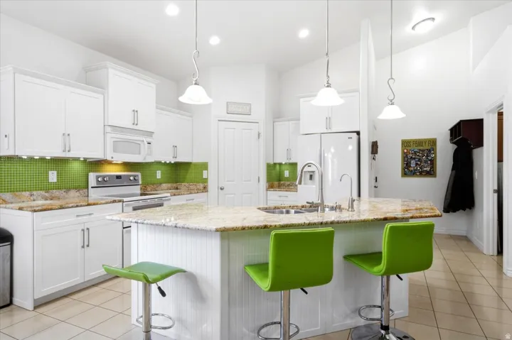 The generous kitchen island provides additional workspace and seating, making it ideal for everyday meals and gathering.