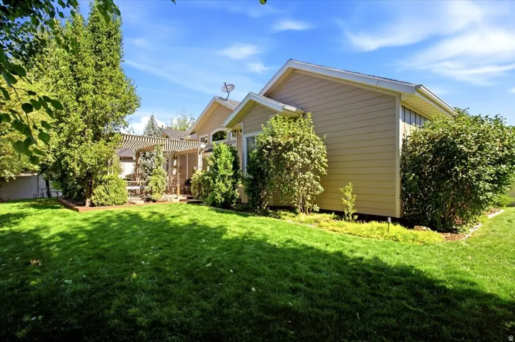 Lush green lawn with mature trees and established landscaping