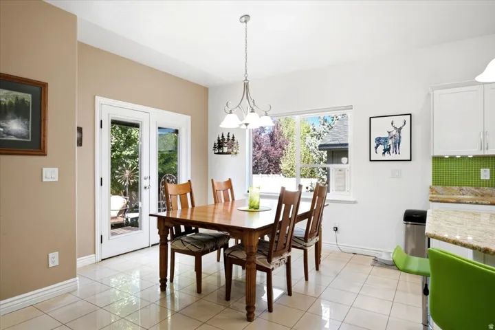 The large dining area is filled with natural light and provides direct access to the custom backyard retreat.