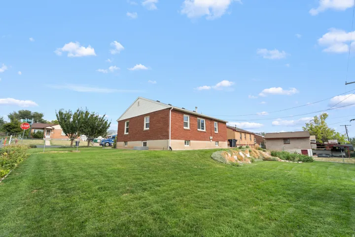 Expansive grass lawn with a tiered rock garden