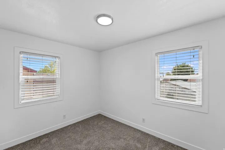 Recessed ceiling light fixture and two windows with blinds