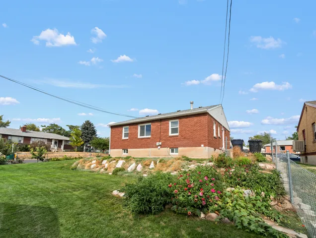Red brick exterior with white trim windows and a sloped roof