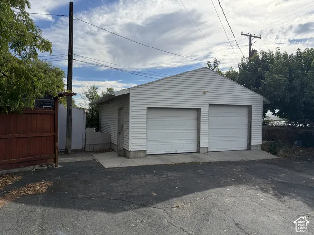 Two-car garage with white siding and individual garage doors