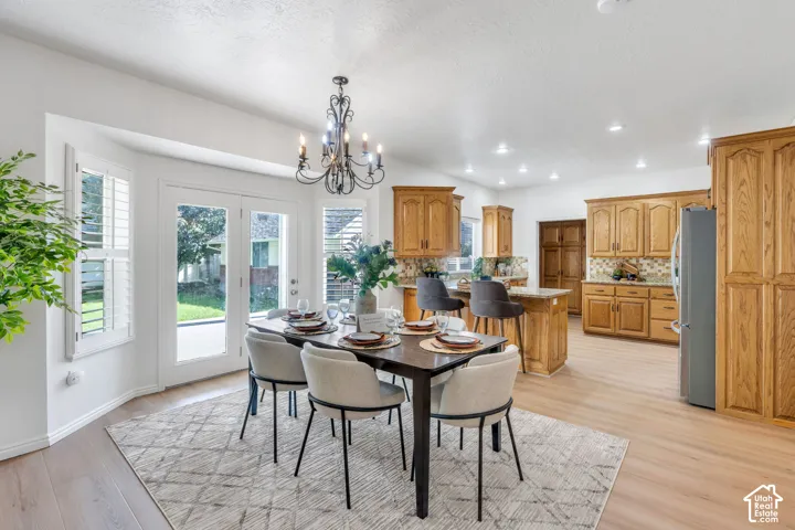 Hardwood-finish flooring, recessed lighting, and a bay window with plantation shutters