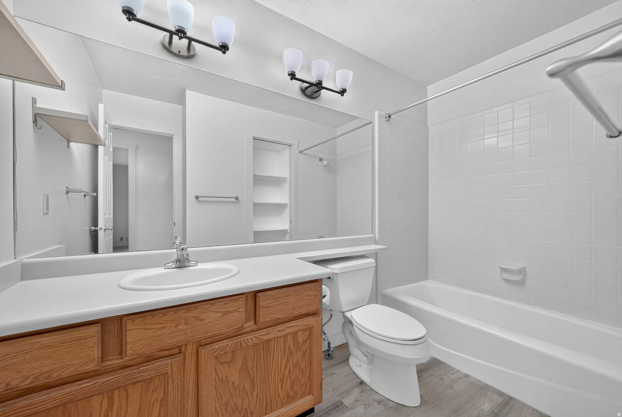 Wood-finish vanity with an integrated sink and chrome faucet