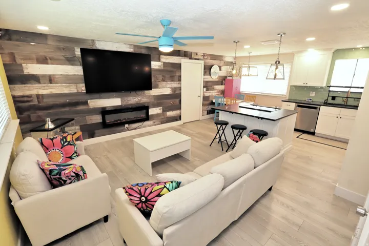 Wood-finish flooring throughout, a custom accent wall, and a built-in electric fireplace