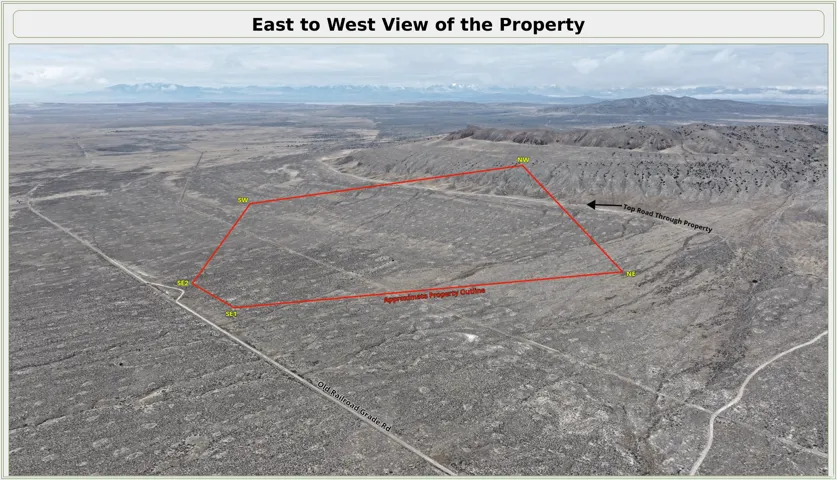 Aerial Photograph. East to West View of the Property, illustrating the approximate property outline and a road within its boundaries