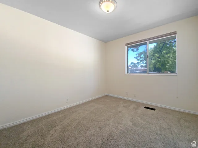 Previous picture Neutral wall color, carpeted flooring, and a single window