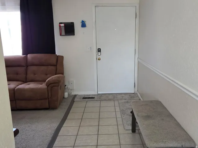 Tiled entryway with light-toned square tiles