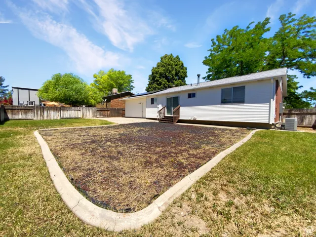 Previous picture backyard featuring a concrete patio, wood fencing, and a white siding exterior