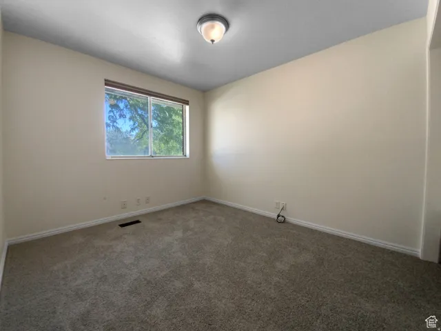 Previous picture Neutral wall color, carpet flooring, window with natural light, flush mount lighting