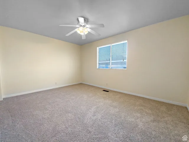 Previous picture Plush carpet flooring, neutral-toned walls, ceiling fan with integrated lighting, and a window with horizontal blinds