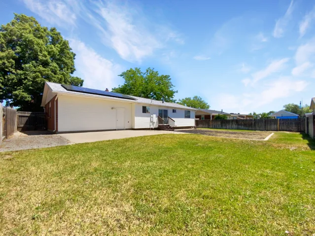 Previous picture: Expansive grass backyard with wood fencing and concrete patio