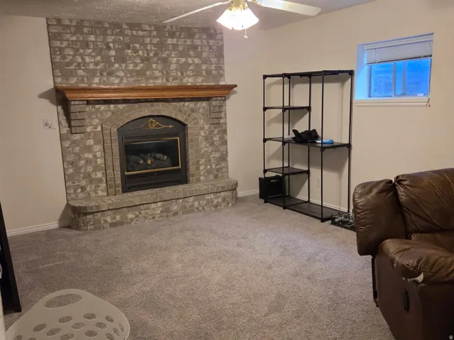 Stone-clad fireplace with a wood-finish mantel and hearth