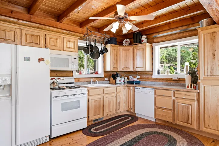 Wood-finish flooring with a ceiling fan overhead