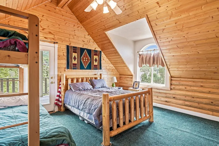 Wood-paneled walls and sloped ceilings throughout
