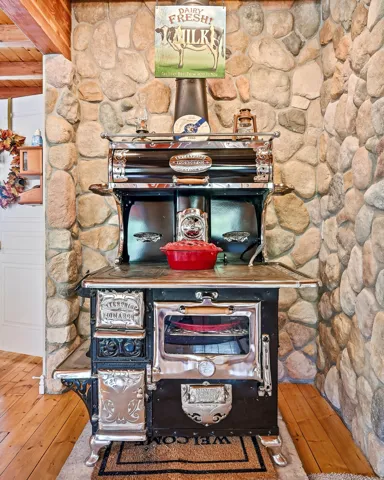 Stone accent wall with an antique-style range