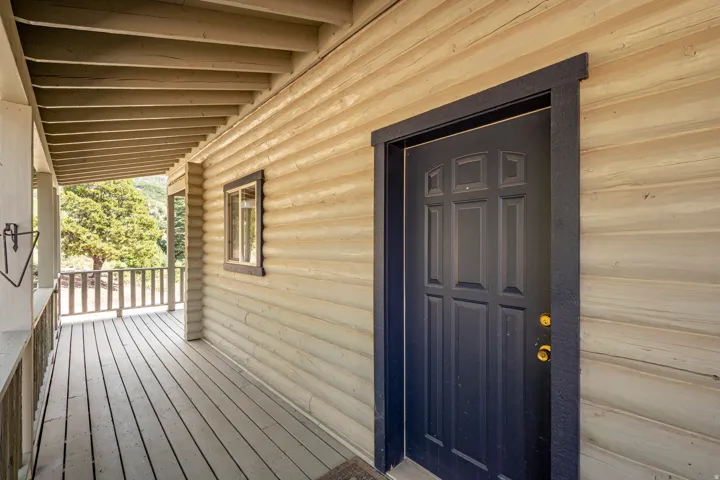 Expansive covered porch with wood plank flooring