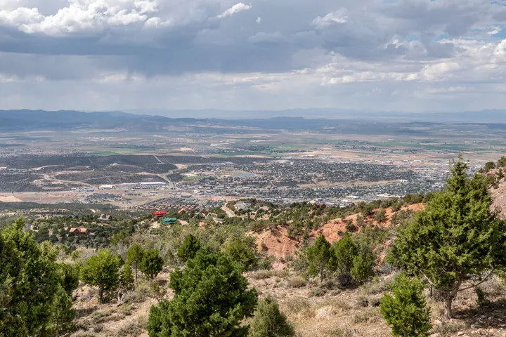 Expansive landscape featuring distant city elements and a mountainous backdrop