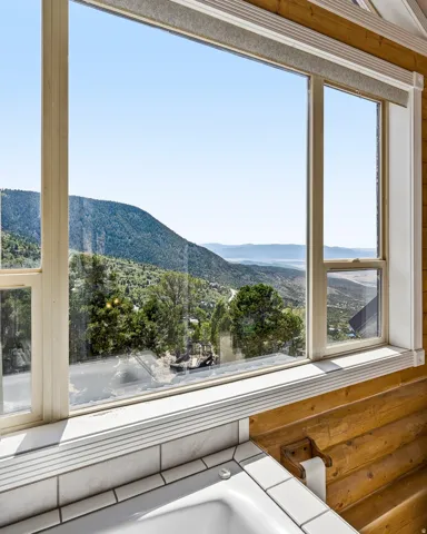 Window with expansive mountain and distant water scenery