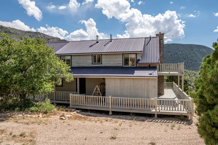 Multi-level exterior with board and batten siding and a metal roof