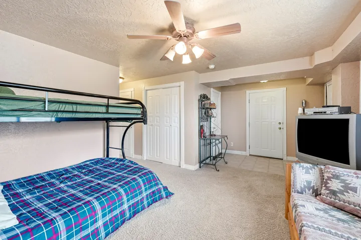 Recessed lighting, ceiling fan, neutral carpet flooring, paneled interior door, and bi-fold closet doors