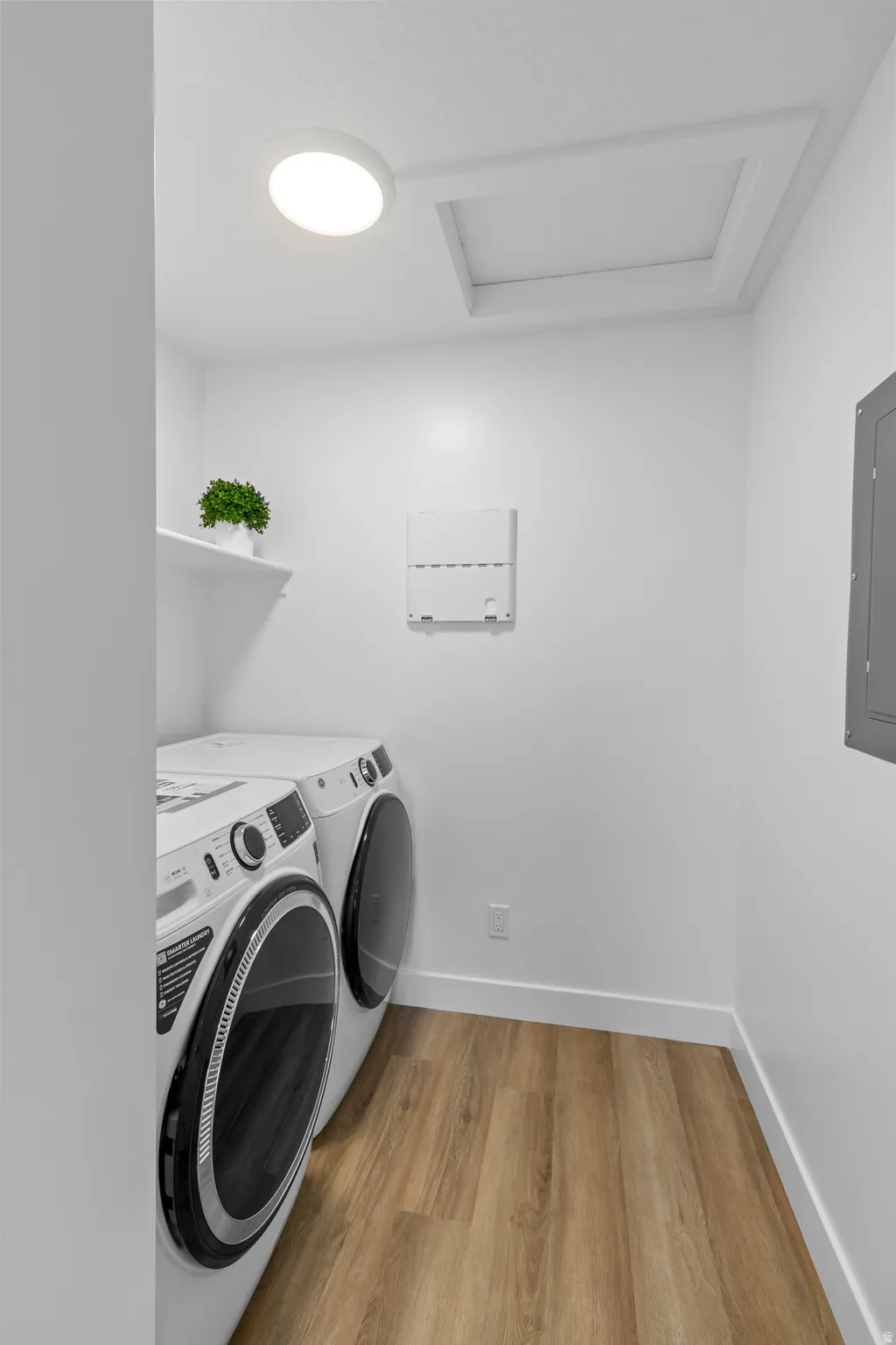 Wood-finish flooring with white baseboards and a ceiling-mounted light fixture