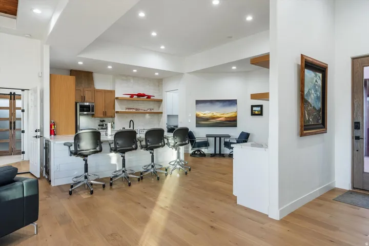 Modern kitchen featuring wood-finish cabinetry, a white countertop, and a tiled backsplash