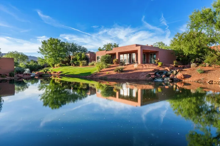 Red rock landscaping with mature vegetation and water features