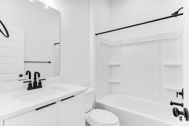 Modern bathroom featuring a clean-lined vanity with integrated sink, white quartz countertop, matte black hardware and faucet, large framed mirror with matte black trim, and a three-piece bathtub-shower combination with subway tile surround and matte blac