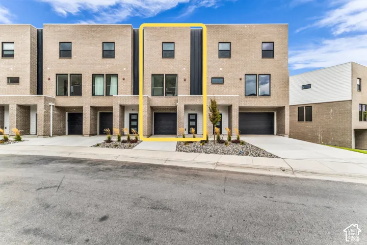 Modern townhome development featuring clean-lined brick and stone facades with contemporary architectural detailing