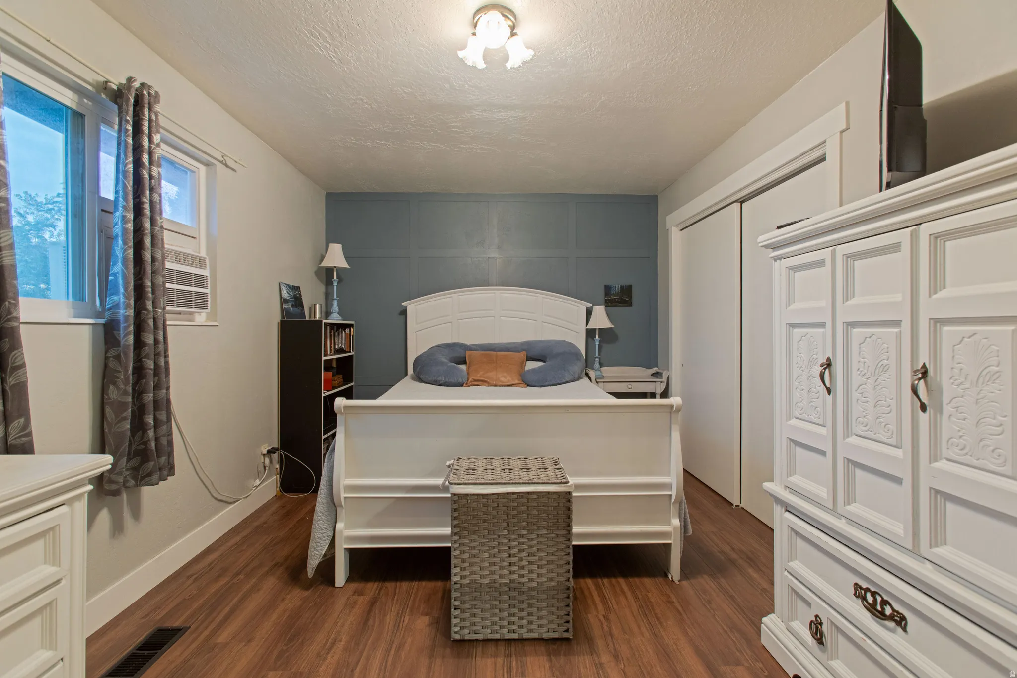 Wood-finish flooring throughout, with a feature wall and white trim