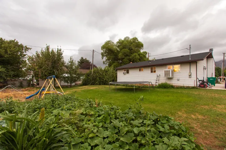 Expansive rear yard with a green lawn area and established landscaping