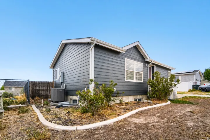 Gray horizontal siding exterior with white window trim and white gutters