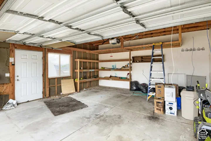 Concrete flooring, exposed framing, and built-in shelving offer functional storage