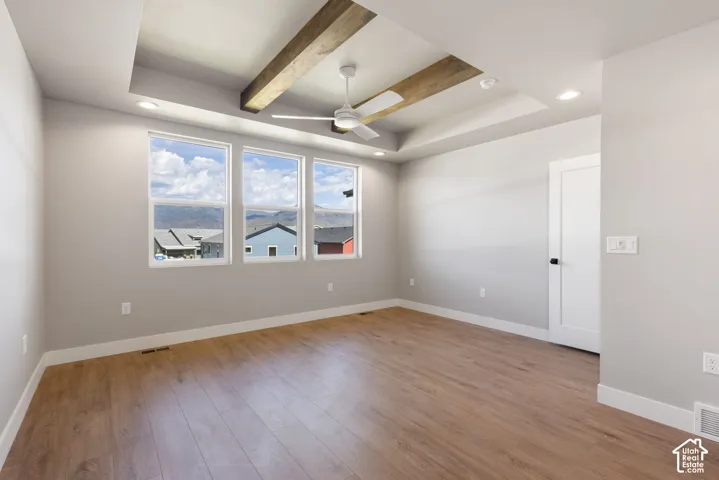 Tray ceiling with wood-finish beams and recessed lighting
