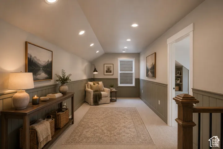 Recessed ceiling lighting, wainscoting, wood-finish console table, and a window with white trim