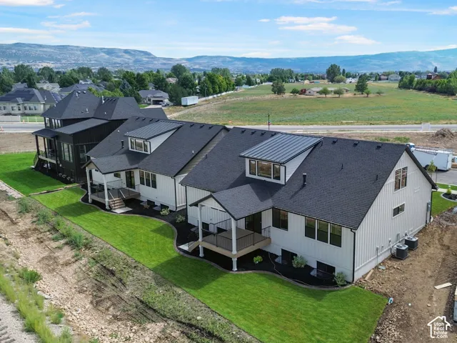 Modern farmhouse-style architecture with white vertical siding and black-framed windows