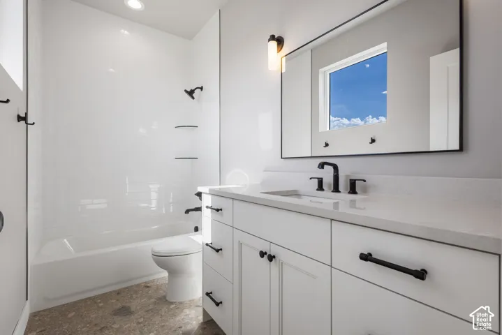White shaker cabinetry with matte black hardware, integrated vanity sink with matte black faucet, and a large rectangular mirror