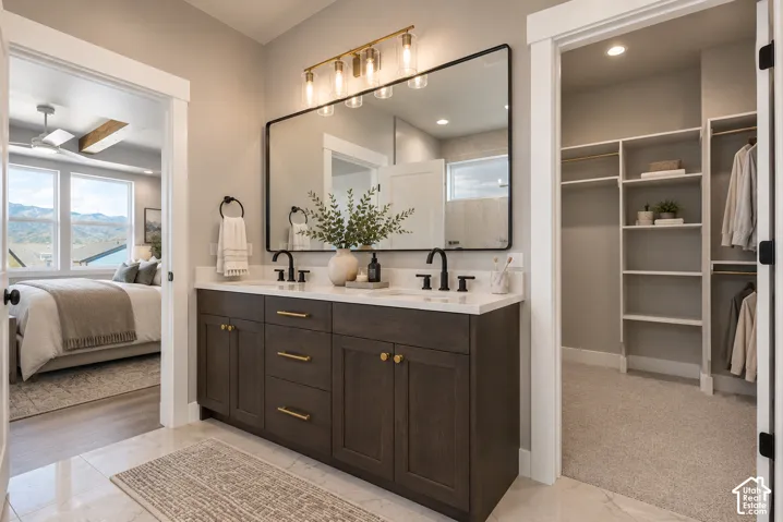 Double vanity with quartz countertop, dark wood-finish cabinetry, and matte black fixtures